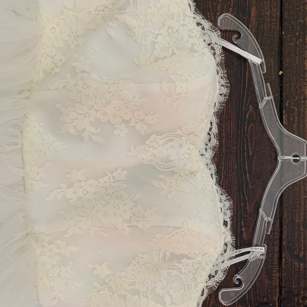 Never worn, strapless, floor length wedding dress. Brand: Love, Yu. Size 16.